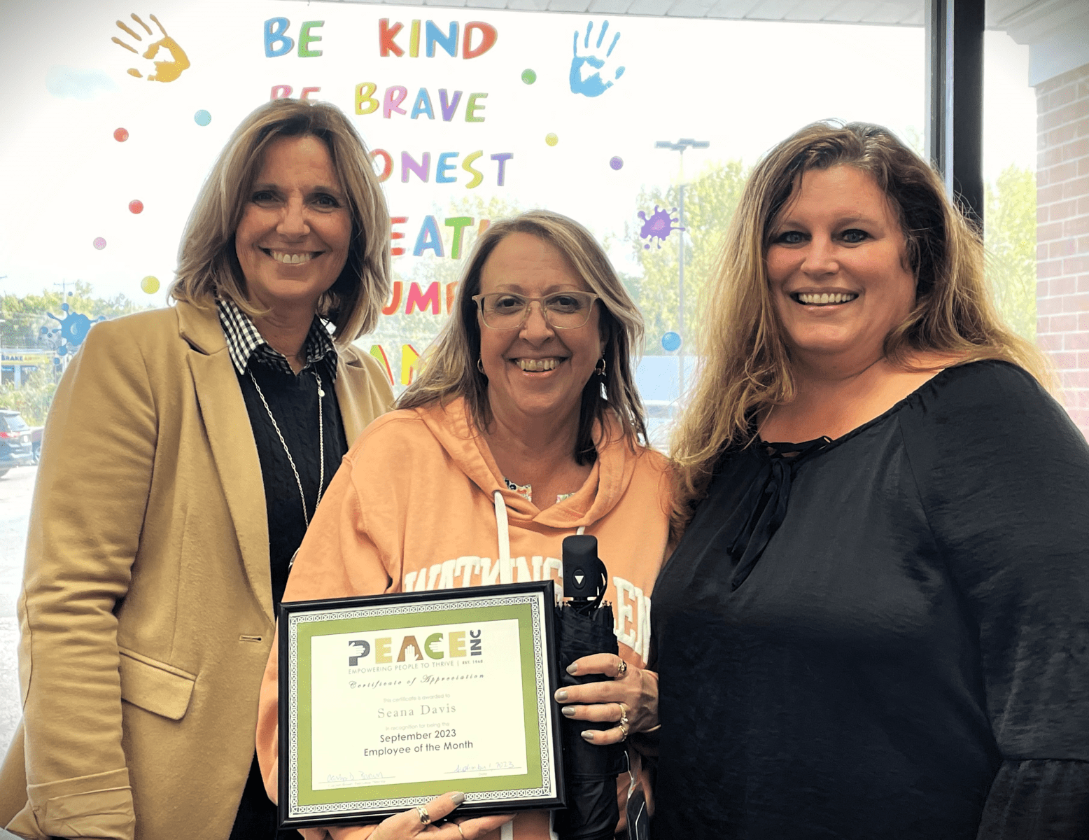 Employee of the Month Seana Davis (center), with Executive Director Carolyn Brown (L) and Liverpool Site Supervisor Kelly Jensen (R).