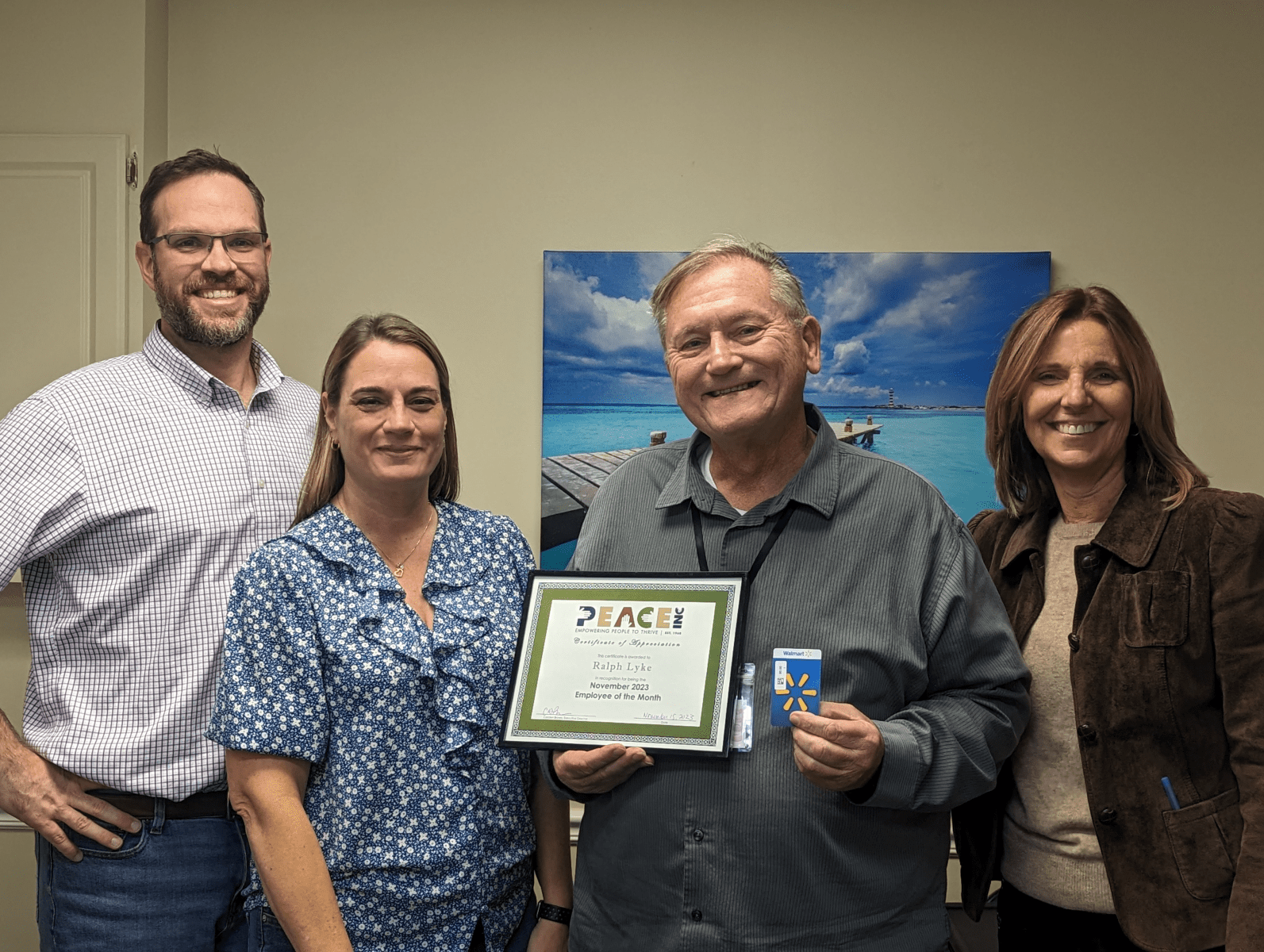 Employee of the Month Ralph Lyke, with (left to right) VP of Operations & Strategy Todd Goehle, Free Tax Prep Program Manager Sharon Thompson, and Executive Director Carolyn Brown.