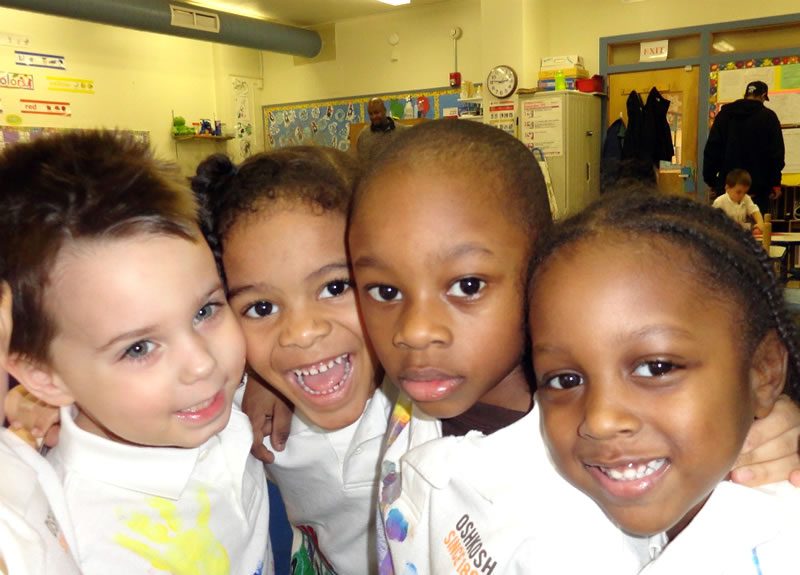 group of four smiling children